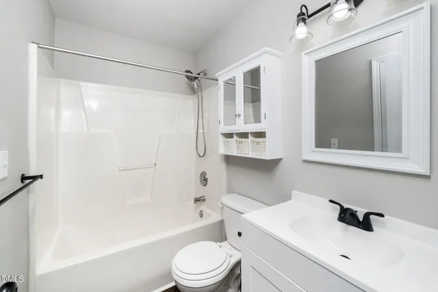 a bathroom with a sink toilet a mirror and shower