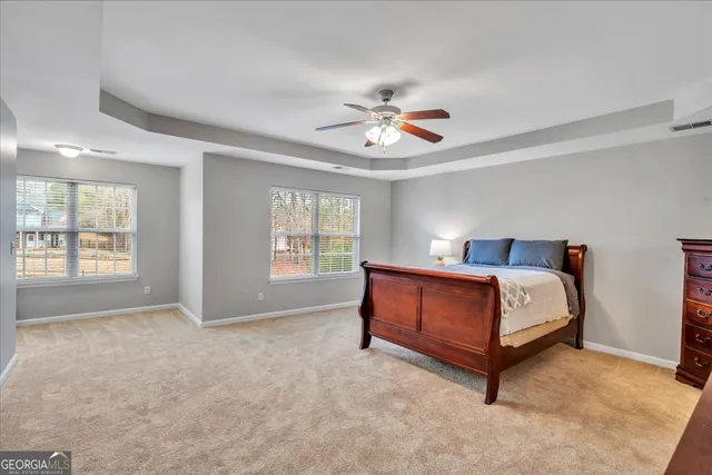 a spacious bedroom with a bed and a window
