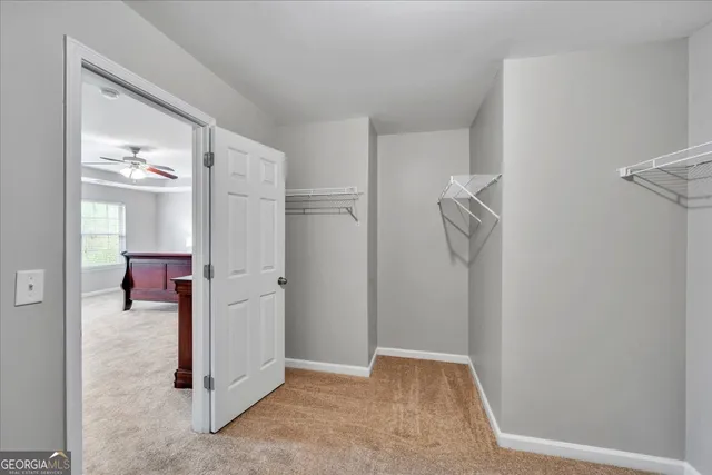a view of a livingroom with tub and closet