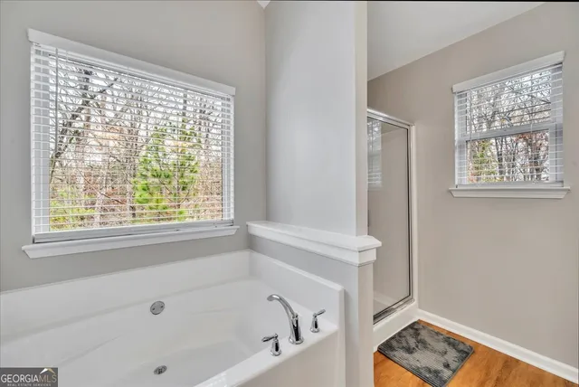 a bathroom with a bathtub and a window