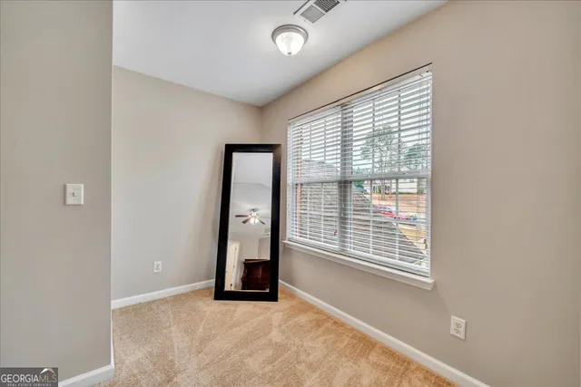 an empty room with windows and closet
