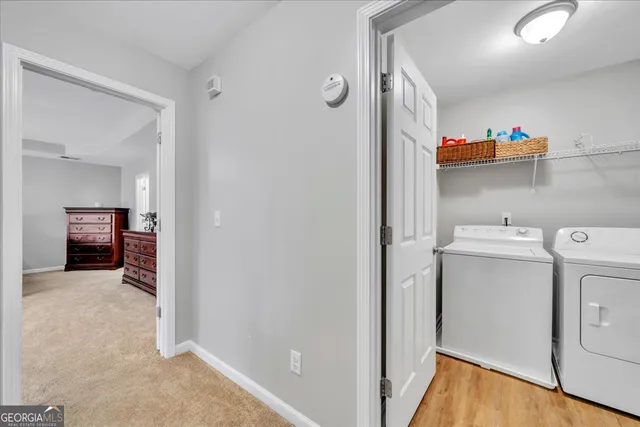 a view of storage and utility room with a washer dryer