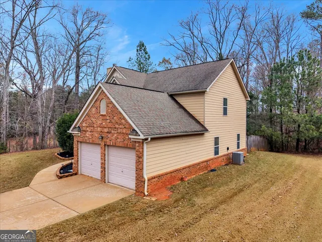 a view of a house with a yard covered in snow