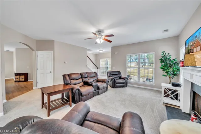 a living room with furniture and a large window