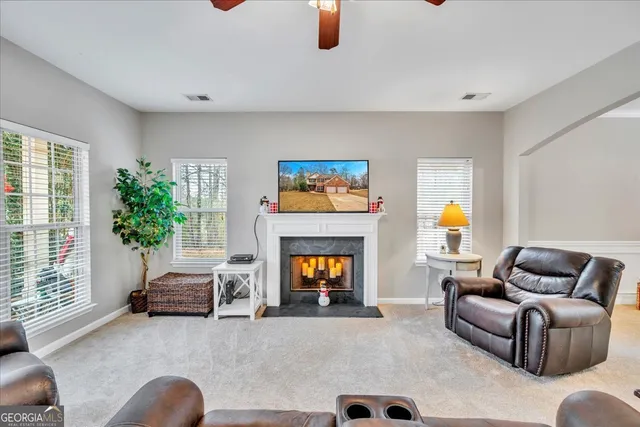 a living room with furniture and a fireplace
