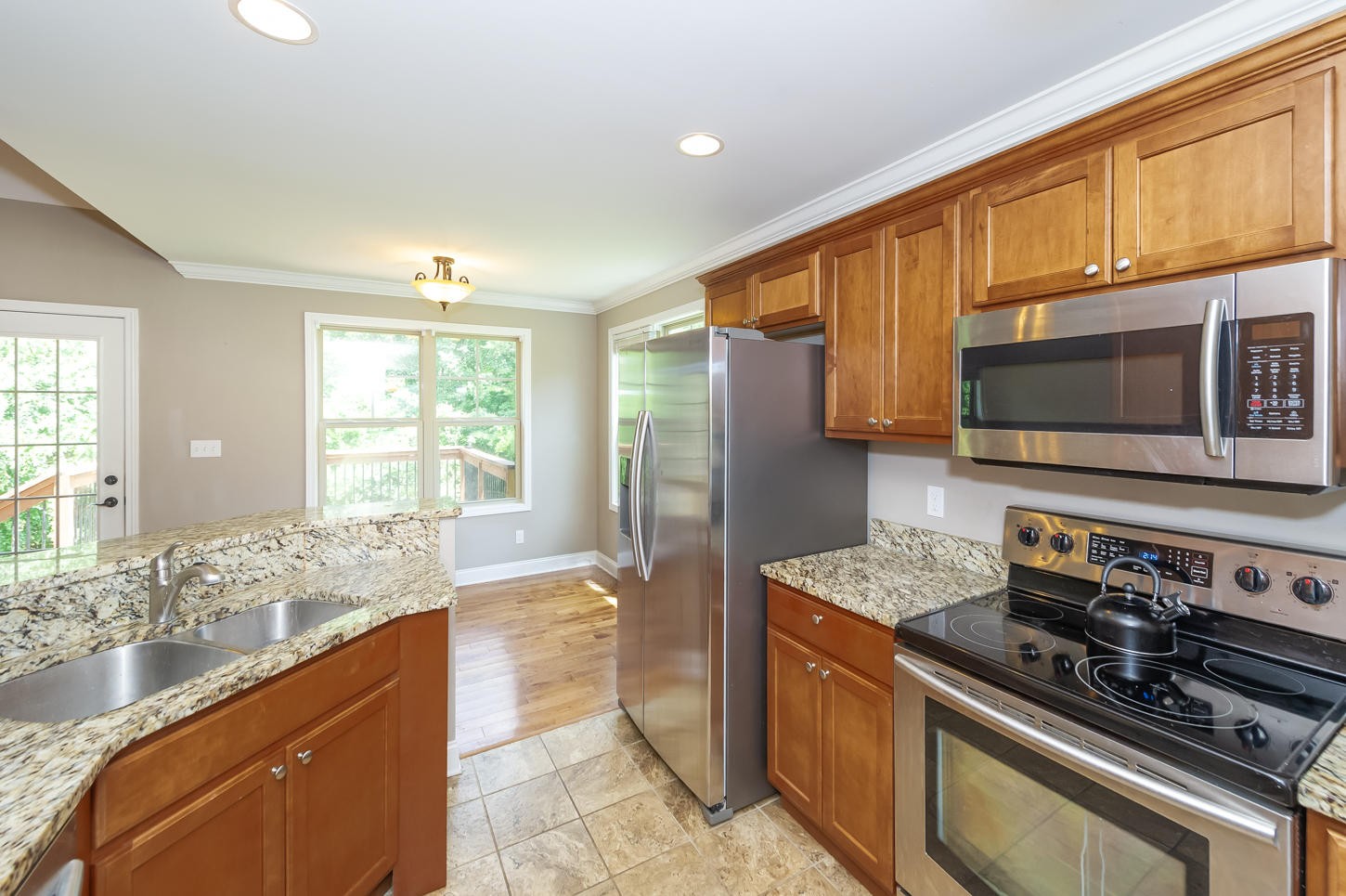 159 Crossroads Boulevard Oak Ridge, TN 37830 - Photo 8 of 28 a kitchen with stainless steel appliances granite countertop a stove a sink and a microwave