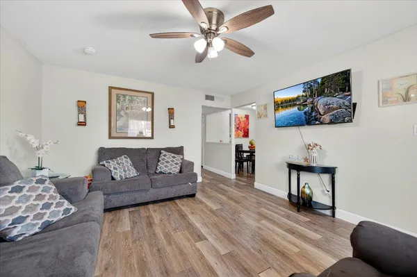 a view of a dining room with furniture and wooden floor
