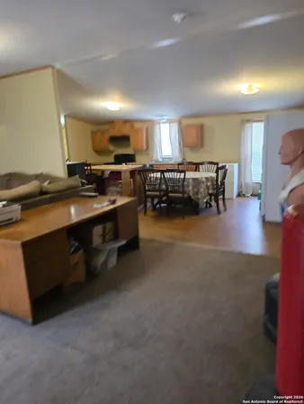 a living room with furniture and a piano