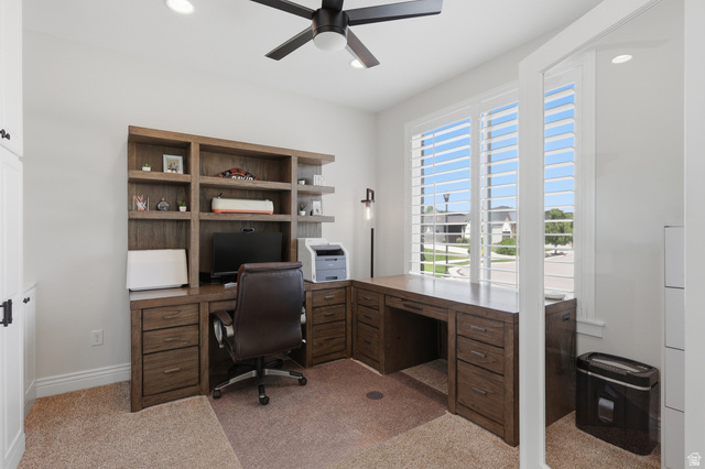 10676 Urban Rdg Cove South Jordan, UT 84095 - Photo 26 of 48 Built-in wood-finish desk with integrated shelving and storage