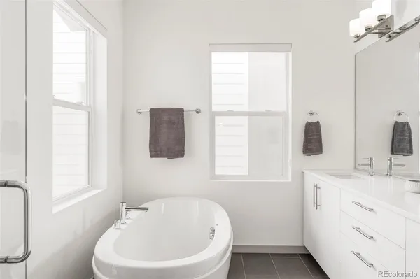 a bathroom with a sink a window and mirror