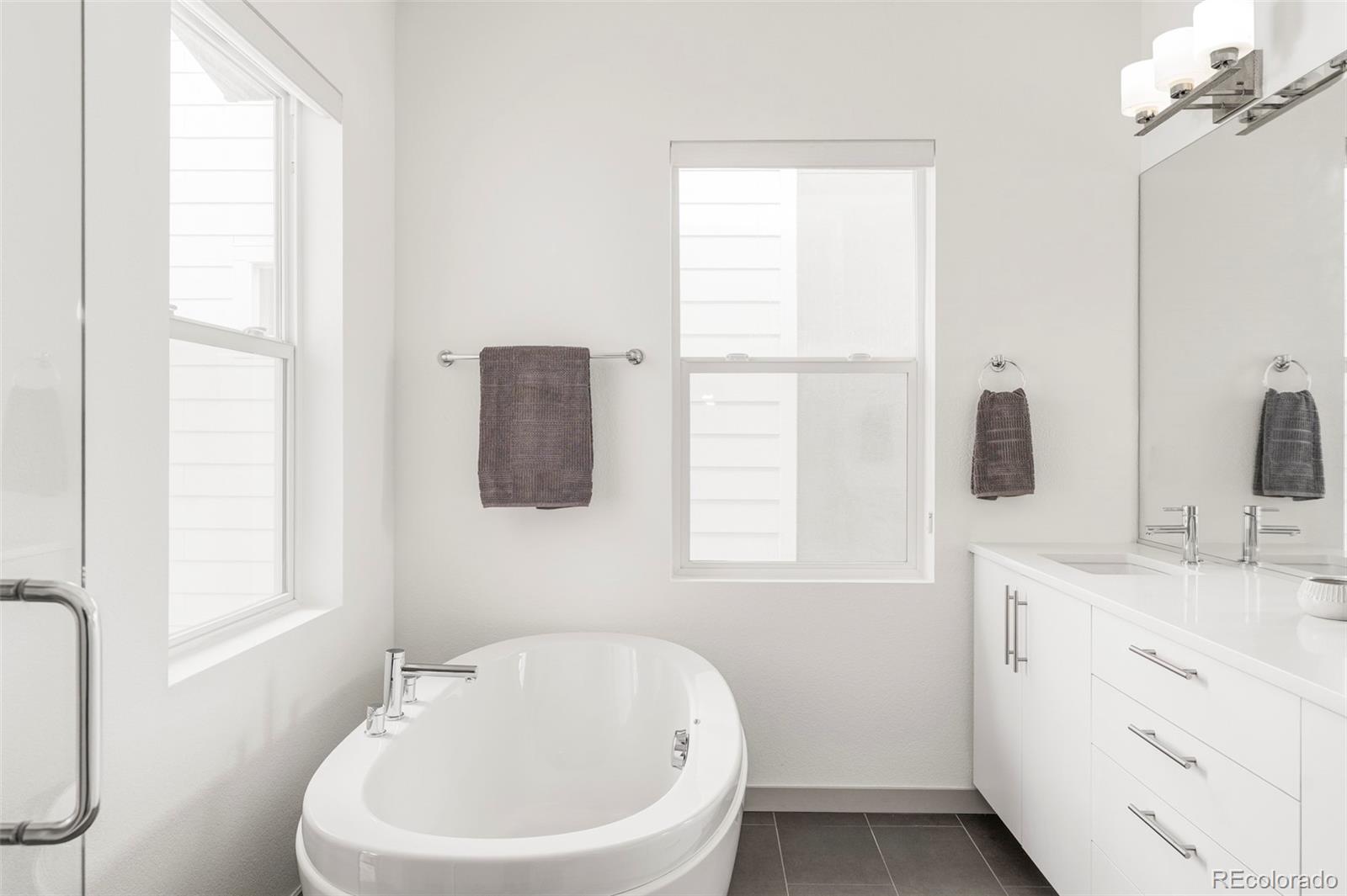 4015 Fenton Court Wheat Ridge, CO 80212 - Photo 14 of 31 a bathroom with a sink a window and mirror