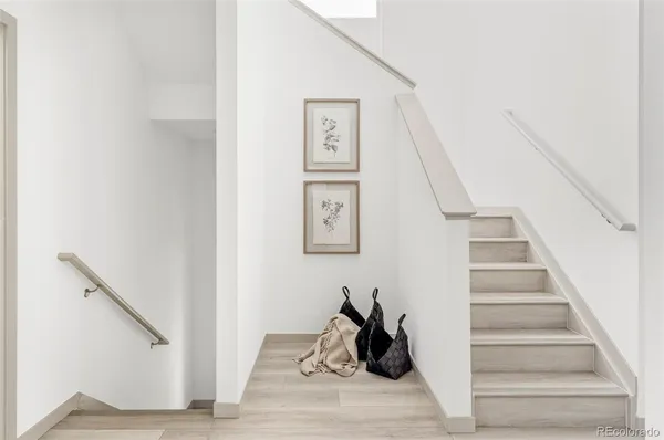 a view of entryway and hall with wooden floor