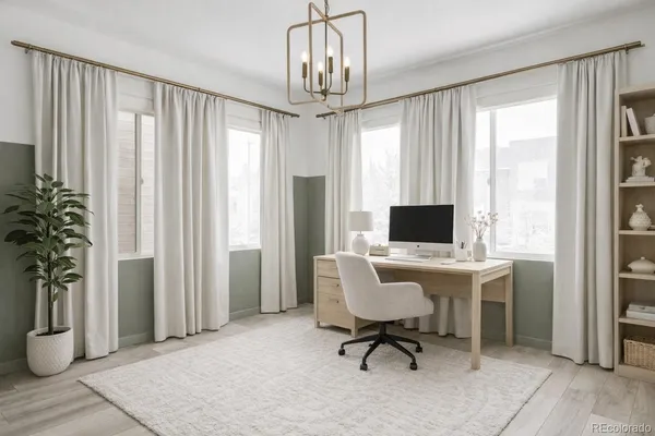 a view of a livingroom with workspace and a window