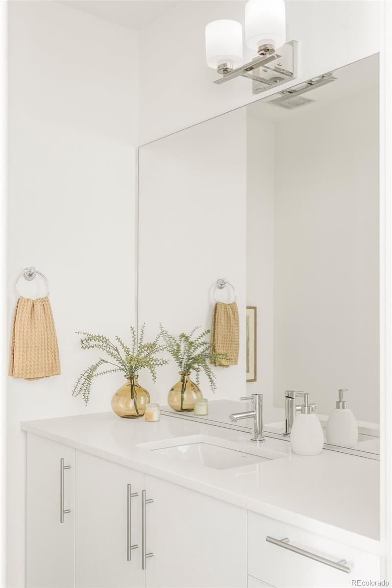 4015 Fenton Court Wheat Ridge, CO 80212 - Photo 8 of 31 a bathroom with a sink and a mirror