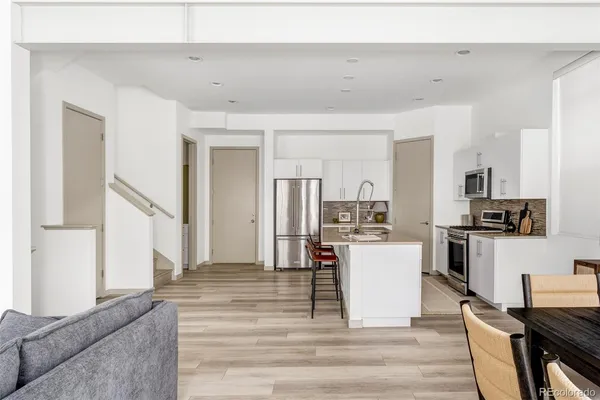 a kitchen with a refrigerator and a stove top oven