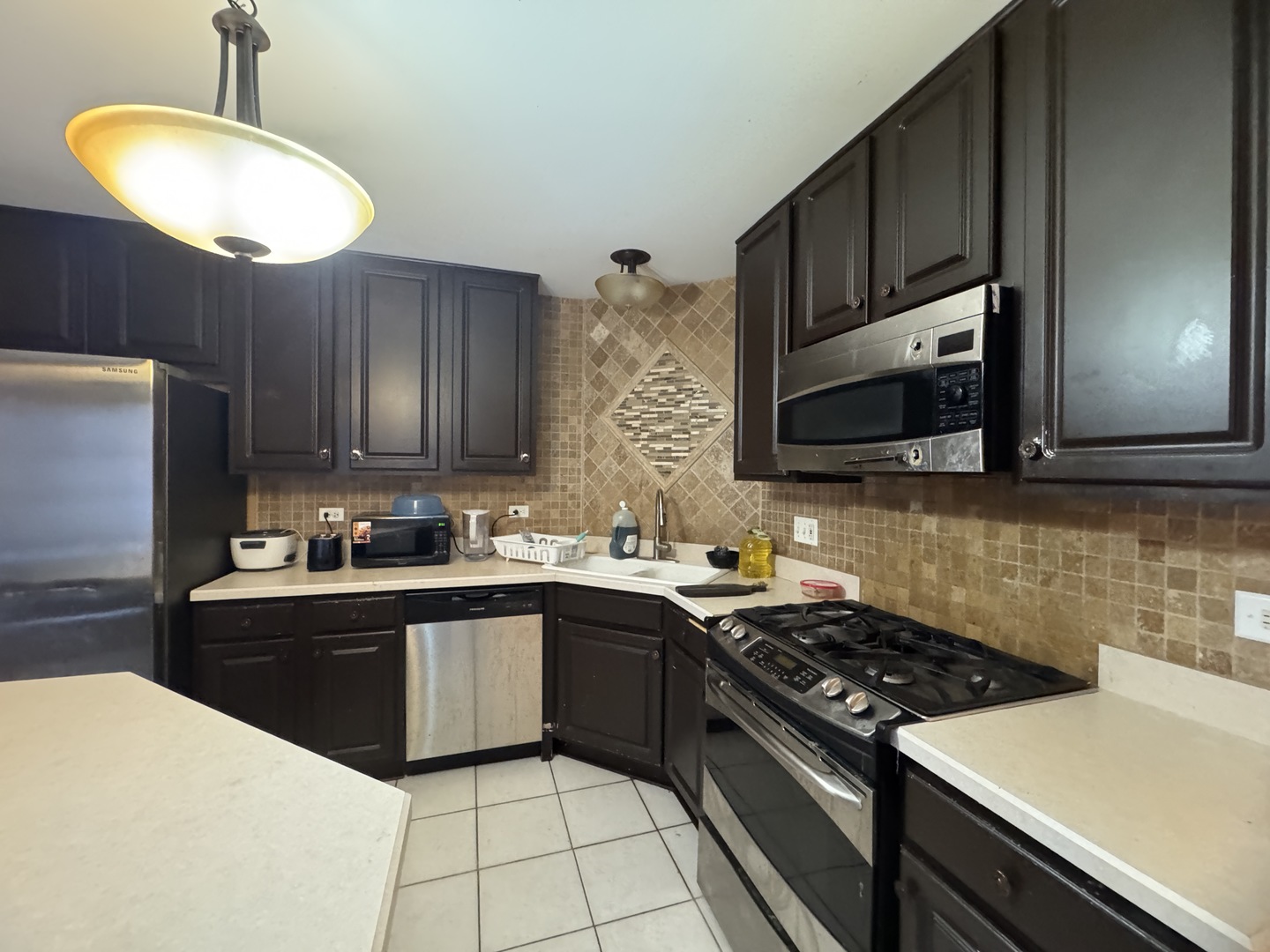 3281 Cool Springs Court Naperville, IL 60564 - Photo 6 of 16 a kitchen with stainless steel appliances a sink dishwasher stove top oven and wooden cabinets