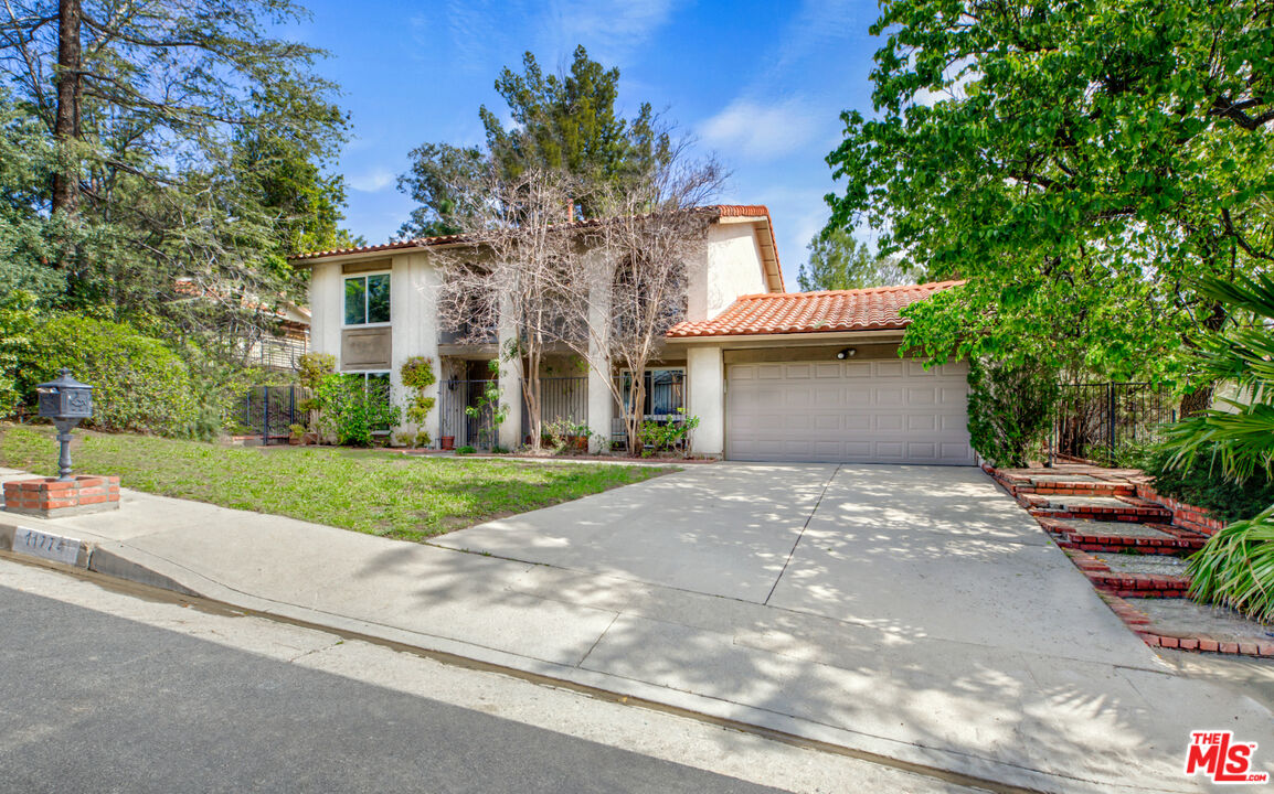 11774 Doral Avenue Porter Ranch, CA 91326 - Photo 1 of 30 a front view of a house with a yard and a garage