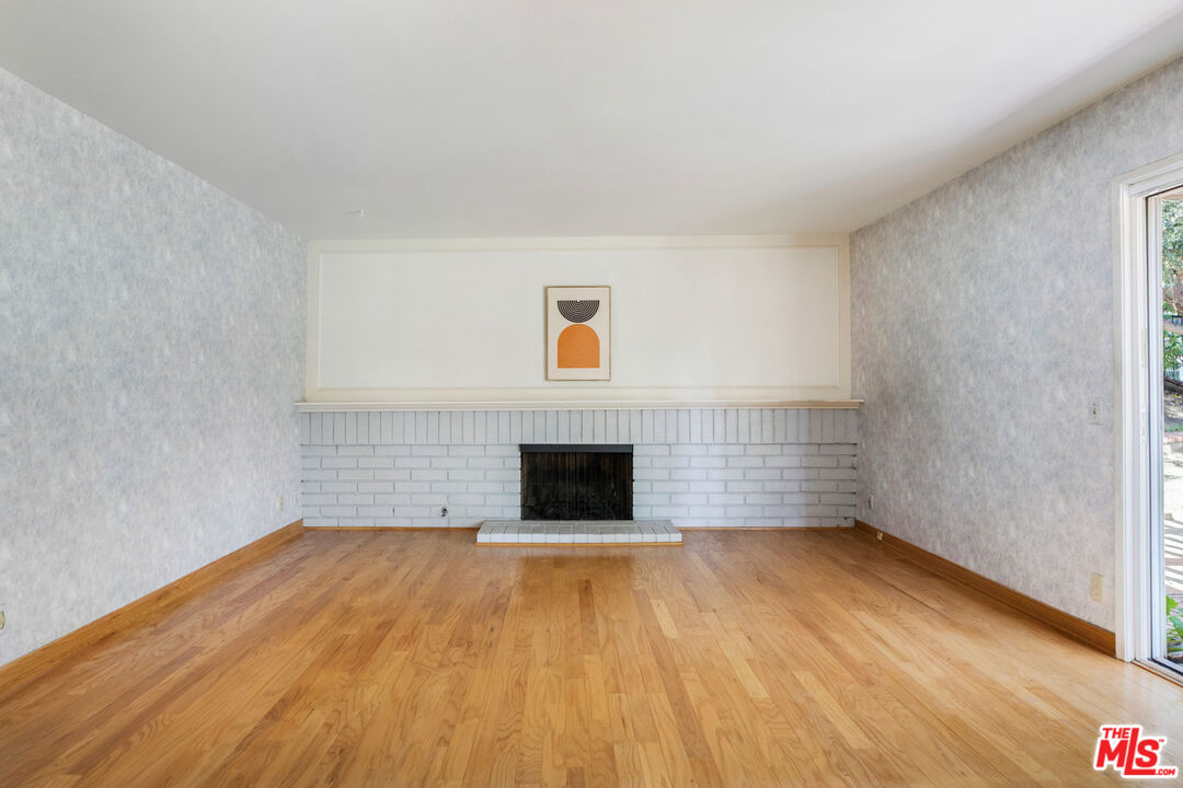 11774 Doral Avenue Porter Ranch, CA 91326 - Photo 15 of 30 a view of empty room with wooden floor and fireplace