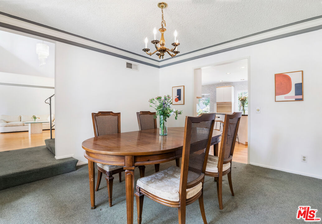 11774 Doral Avenue Porter Ranch, CA 91326 - Photo 17 of 30 a view of a dining room with furniture and chandelier