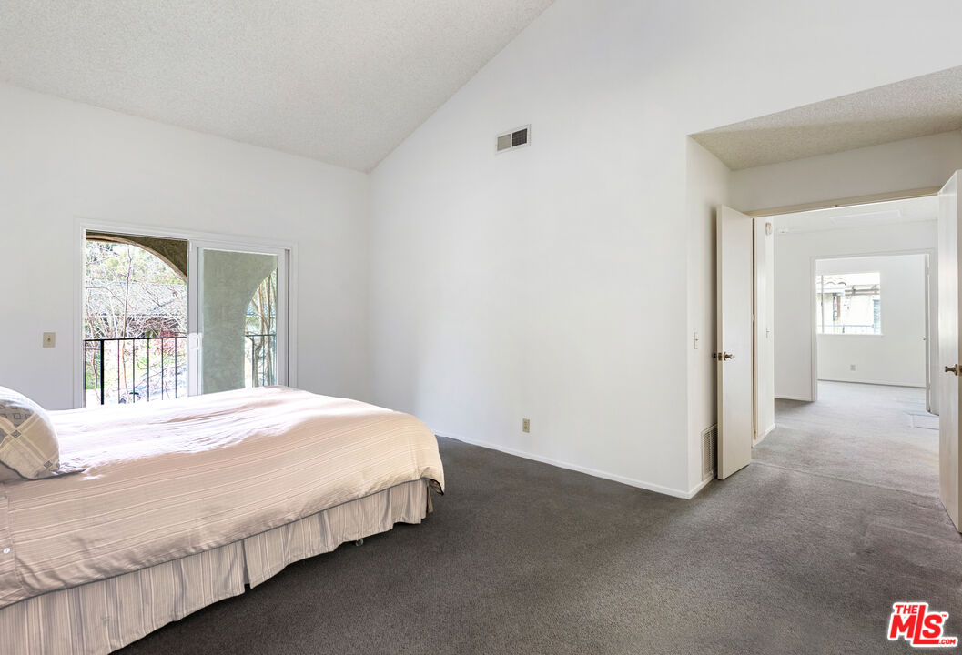 11774 Doral Avenue Porter Ranch, CA 91326 - Photo 20 of 30 a bedroom with a bed and window