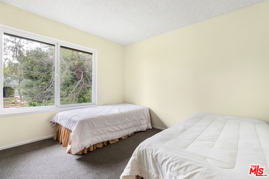 11774 Doral Avenue Porter Ranch, CA 91326 - Photo 28 of 30 a bed sitting in a bedroom next to a window