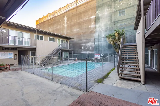 a view of a house with pool and chairs