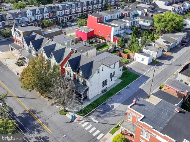 an aerial view of a houses with yard