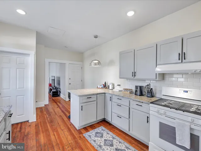 a kitchen with a sink stove and cabinets