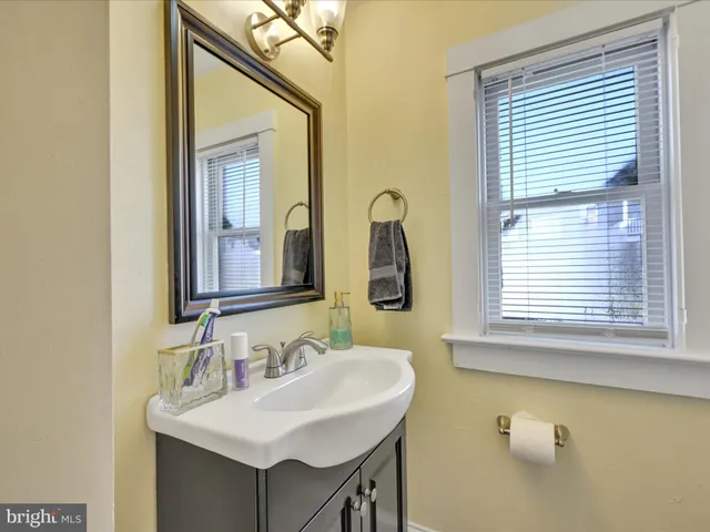 a bathroom with a sink vanity and a mirror