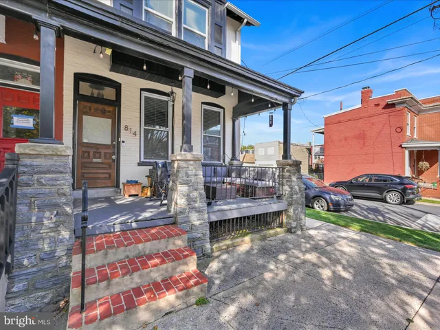 a front view of a house with outdoor seating
