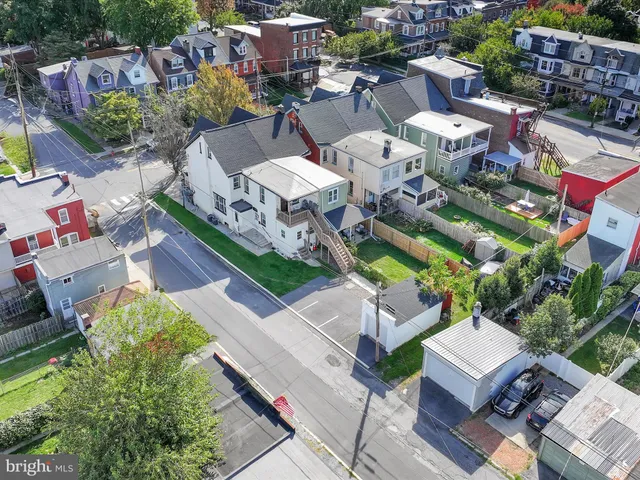 an aerial view of a house with garden space and street view
