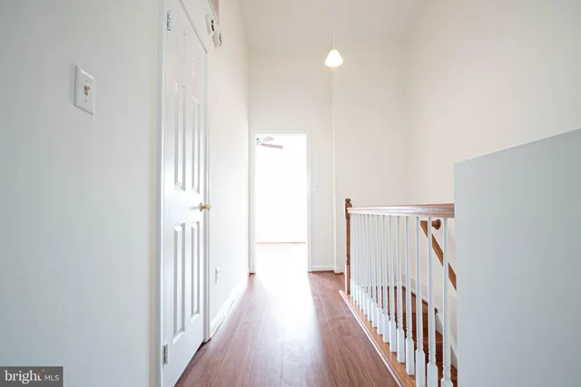 a view of a hallway with wooden floor and entryway