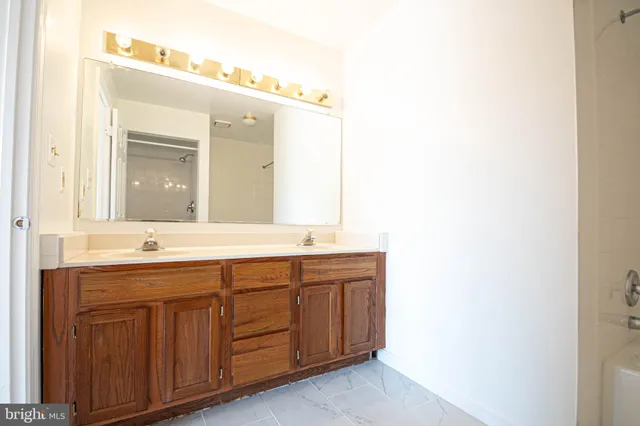 a bathroom with a double vanity sink and a mirror