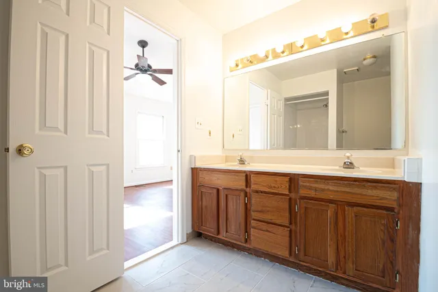 a bathroom with a double vanity sink and a mirror