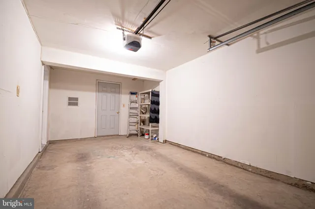 an empty room with closet and windows