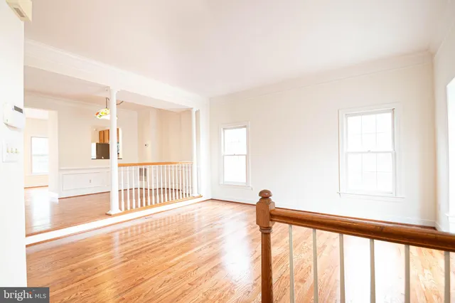 a view of a room with wooden floor and windows