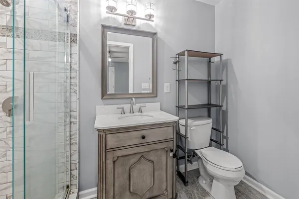 a view of empty room with window and wooden floor