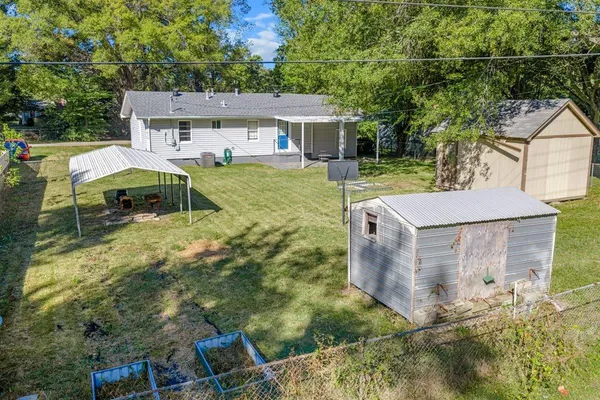 an aerial view of a house with a yard