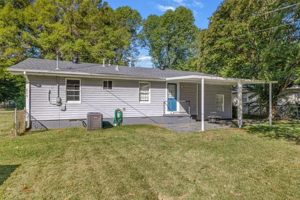 a view of a backyard with a garden and entertaining space