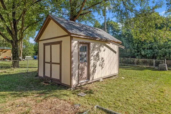 a view of backyard with tub and trees