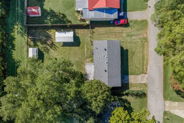 a aerial view of a house with garden space and street view