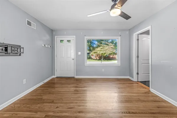 a living room with furniture a window and a flat screen tv