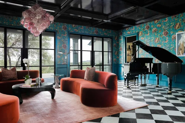 a living room with furniture and a floor to ceiling window