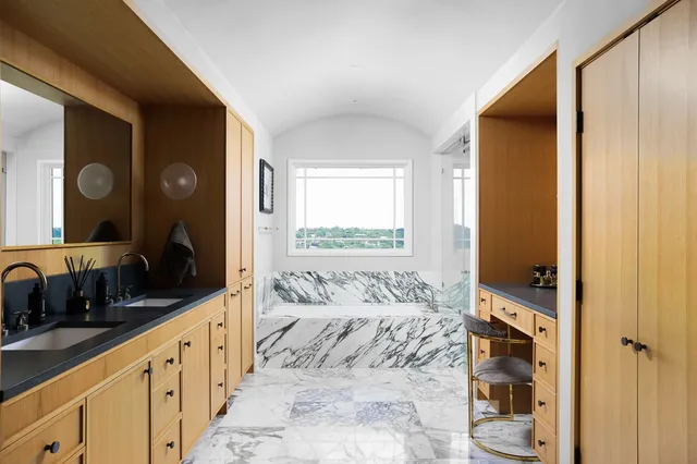 a bathroom with a double vanity sink toilet and shower