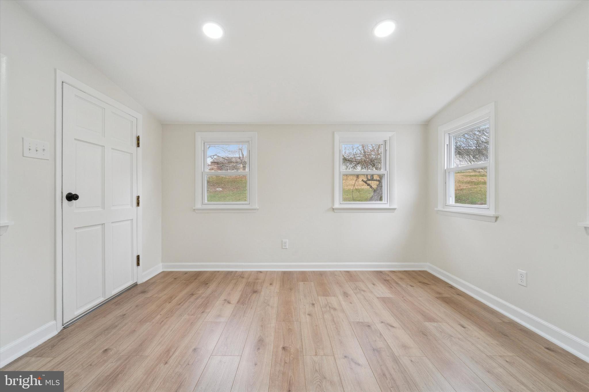 2672 Crownview Road Pottstown, PA 19464 - Photo 20 of 25 an empty room with wooden floor and windows