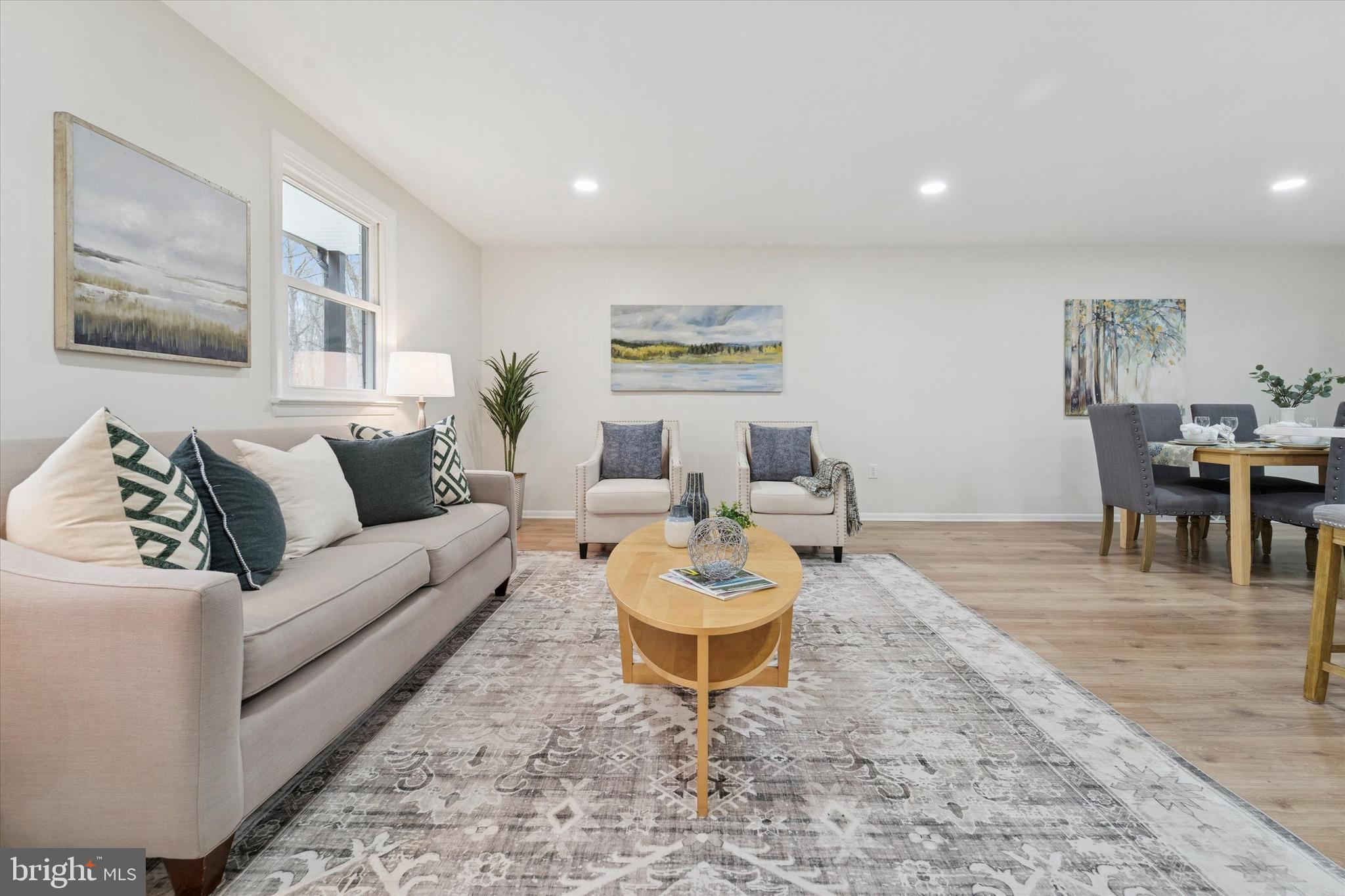 2672 Crownview Road Pottstown, PA 19464 - Photo 5 of 25 a living room with furniture a dining table and a piano with wooden floor