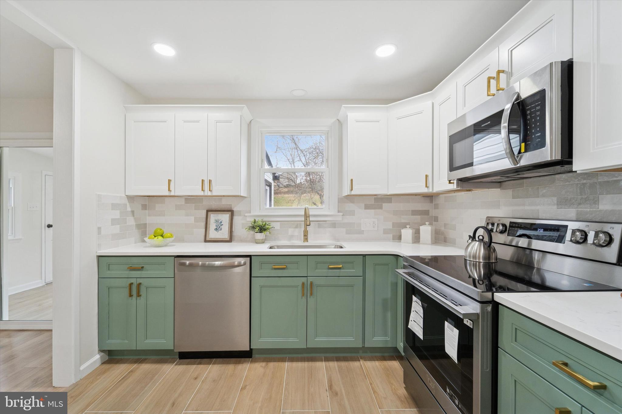 2672 Crownview Road Pottstown, PA 19464 - Photo 10 of 25 a kitchen with stainless steel appliances granite countertop a sink stove and cabinets