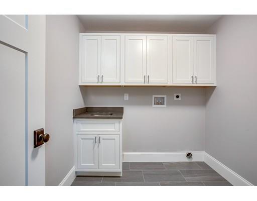 11 Vine Brook Road Lexington, MA 02421 - Photo 27 of 37 a kitchen with white cabinets and a stove