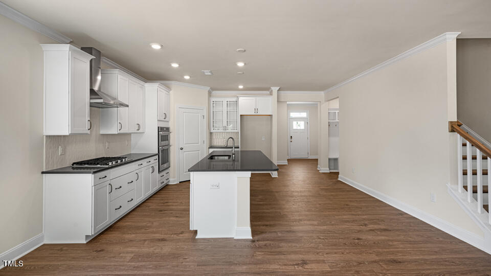 154 Red Jasper Way Clayton, NC 27520 - Photo 12 of 33 a large kitchen with stainless steel appliances kitchen island a large counter top and a wooden floors