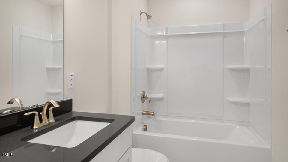 154 Red Jasper Way Clayton, NC 27520 - Photo 18 of 33 a bathroom with a tub sink and mirror